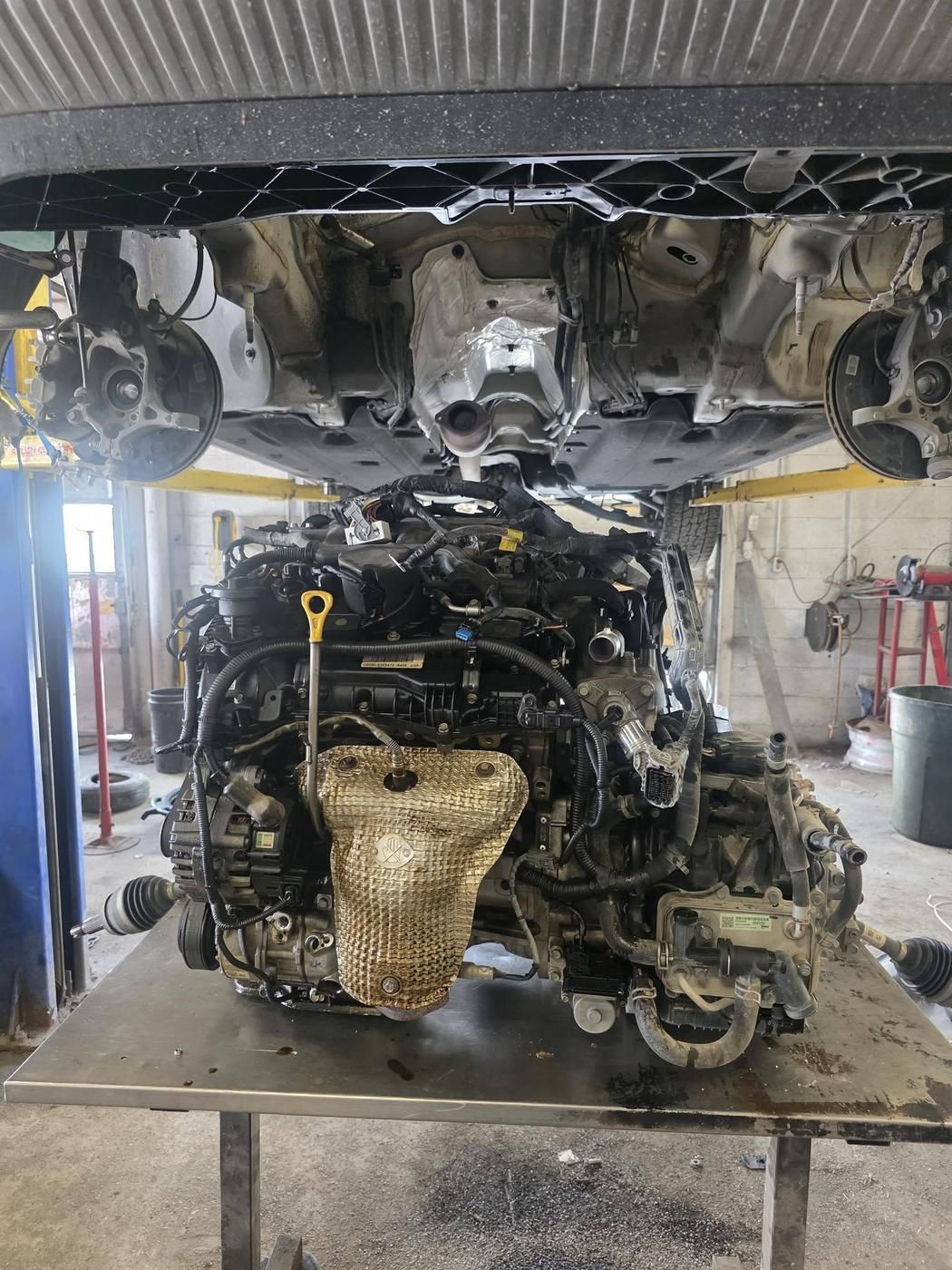 Working under the raised body after the engine drop.